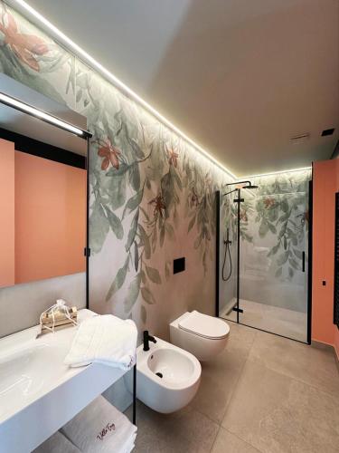 a bathroom with a tub and a toilet and a sink at Villa Emy Boutique Bed & Breakfast in Bisceglie