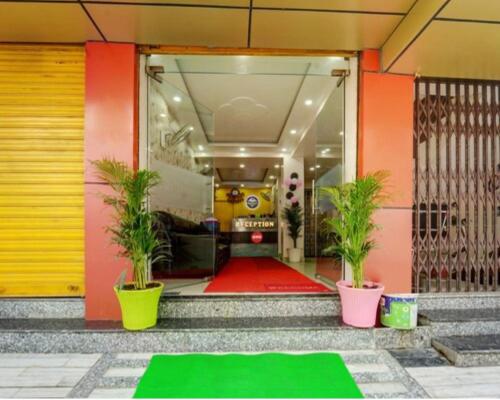 a front door of a house with a green mat in front at Hotel The mid town inn in Patna