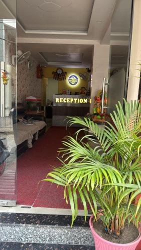 a hospital entrance with plants in a room at Hotel The mid town inn in Patna