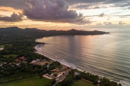 an aerial view of a beach at sunset at Suite 3 Jaguar - Beach & Pool 2 BR Condo in Brasilito