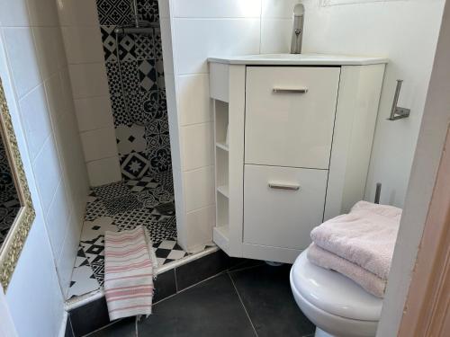 a bathroom with a white cabinet and a toilet at Home St. Germain in Trouville-sur-Mer