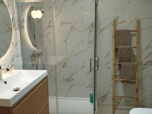 a bathroom with a glass shower and a sink at Casa 35 Barrio El Charco Puerto del Rosario in Puerto del Rosario