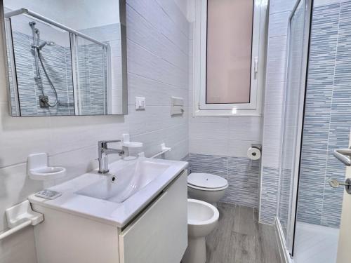 a white bathroom with a sink and a toilet at La Casa Di Giorgio in Sanremo