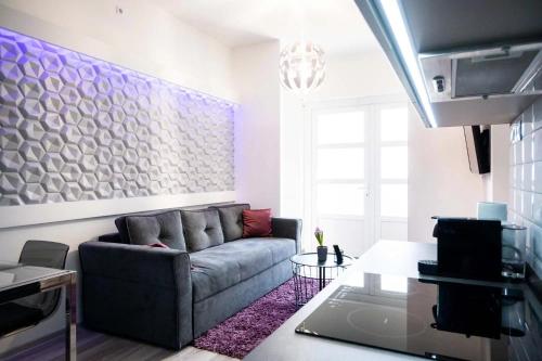 a living room with a couch and a table at Zoé Apartman in Szarvas