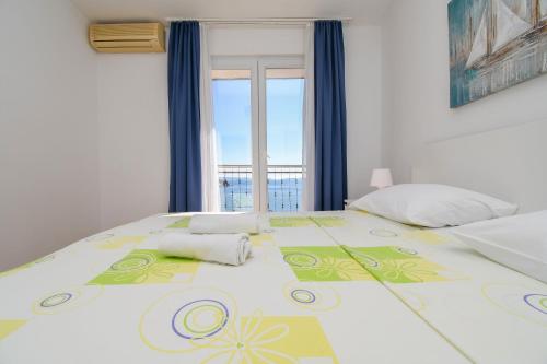 Posteľ alebo postele v izbe v ubytovaní Apartments Rose