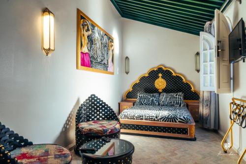 a bedroom with a bed and a chair at PALACIO AL ANDALUS in Chefchaouene