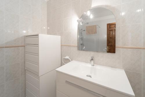 a white bathroom with a sink and a mirror at WELCS CASA ADOSADA 215 EMP con piscina comunitaria in Roses