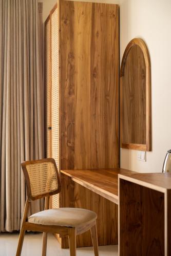 a kitchen with a wooden counter and a chair at Triton Dondra in Dondra West