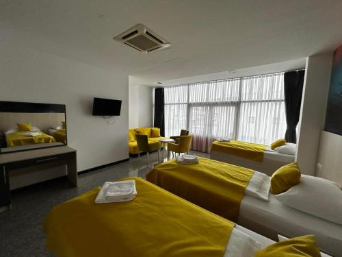 a hotel room with two beds and a tv at Prenoćište Euro-Jet Ćoralići in Ćoralići