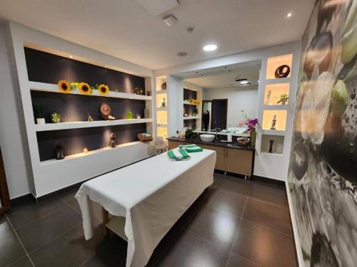 a room with a white table and a kitchen at Bakuriani Orbi Palace Luxe Suite with Terrace and Breathtaking Views 462 in Bakuriani