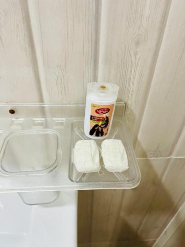 a small refrigerator with a sink and a container of milk at Piyasa Rest in Sigiriya