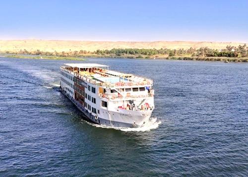 a large boat on the water in a river at Luxor Or Aswan Nile Cruise, Ultra Deluxe sailing 3, 4, Or 7 Nights in Luxor