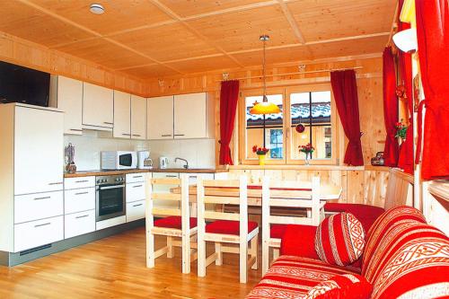a kitchen and dining room with a table and chairs at Ferienhaus Eberharter in Schwendau