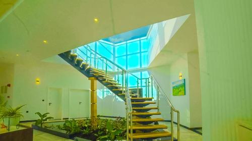 a staircase in a building with a glass ceiling at Chebera Elephant Paw Lodge in Bokdē