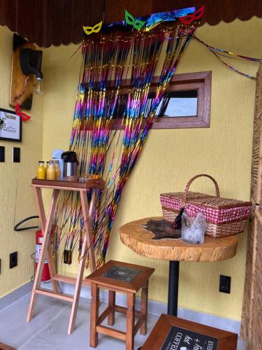 a room with a table and a basket on a wall at Miradouro São Pedro da Serra in São Pedro da Serra