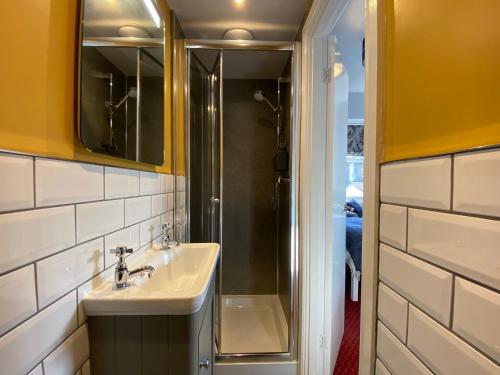 a bathroom with a sink and a shower at Goodwin House in Keswick