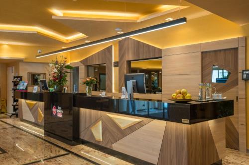a lobby with a counter with a bowl of fruit on it at Best Western Plus Hotel Füssen in Füssen