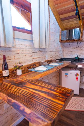 a kitchen with two sinks and a wooden counter at Pousada Alpes da Mantiqueira in Monte Verde