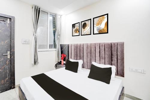 a bedroom with a large white bed with two pillows at The Byke Express - Avanti Residency - Ujjain in Ujjain