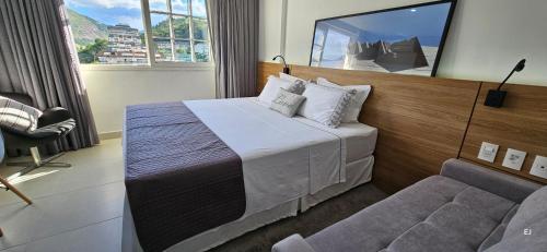 a hotel room with a bed and a couch at Imperial Studio - Itaipava - Granja Brasil Resort in Petrópolis
