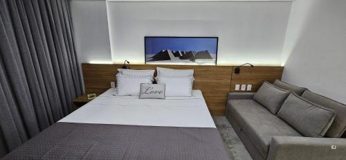a hotel room with a bed and a couch at Imperial Studio - Itaipava - Granja Brasil Resort in Petrópolis