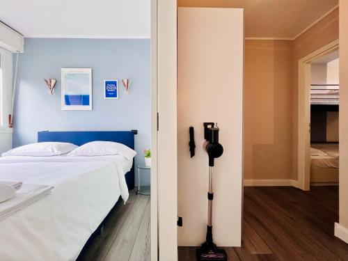 a bedroom with a bed and a camera on a tripod at Vespa Azzurra Apartments Free Parking in Acquaseria