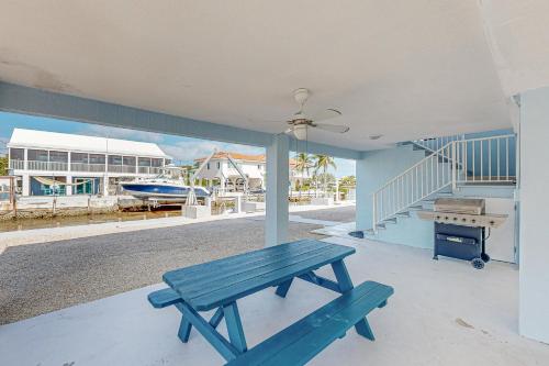 a blue picnic bench sitting on the porch of a house at Seabreeze Haven in Marathon