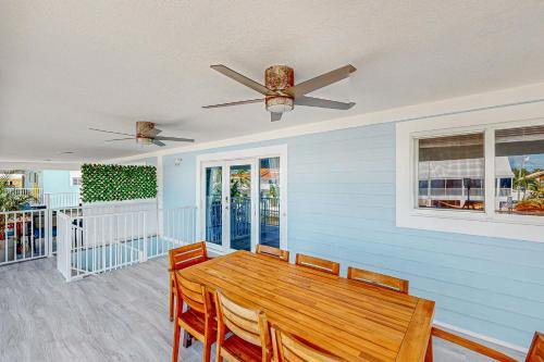 a dining room with a wooden table and a ceiling fan at Seabreeze Haven in Marathon