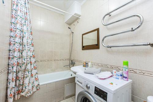 a bathroom with a washer and a washing machine at Однушка в центре Алматы, до Арбата 5 минут ходьбы #82 in Almaty