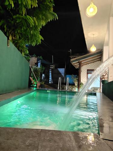 a swimming pool with a water fountain at Nice View Safari villa in Udawalawe