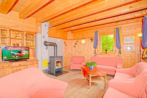 a living room with a fireplace and a tv at Ferienhaus Eberharter Nr 4 in Stumm