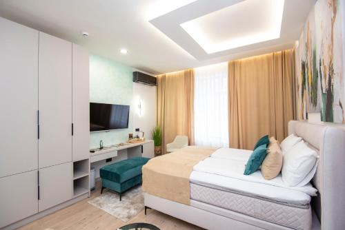 a hotel room with a bed and a television at Bella Suites Apartments - FREE PARKING-GARAGE in Sarajevo