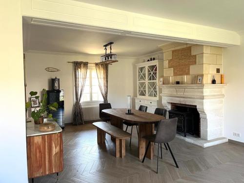 un salon avec une table et une cheminée dans l'établissement 4-bedroom house Le Mans, à Pruillé-le-Chétif