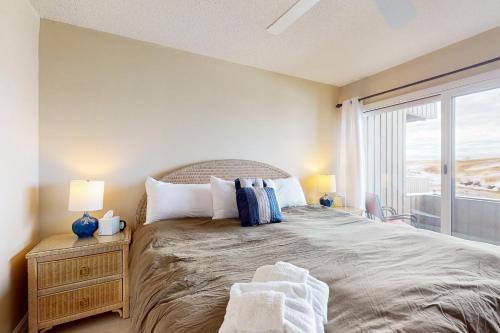 a bedroom with a large bed and a window at Great Lakes 11 in Glen Arbor