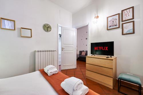 a bedroom with a bed and a tv on a dresser at Rome Bloom - Navona in Rome