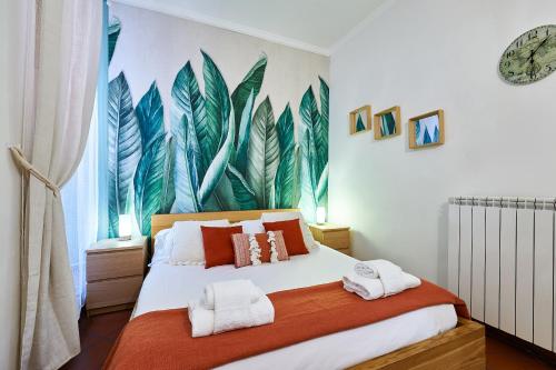 a bedroom with a bed with a mural of leaves at Rome Bloom - Navona in Rome