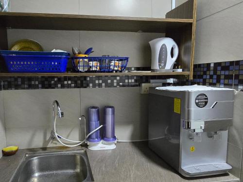 a kitchen counter with a sink and a mixer at 1813 HOME STAY 8 Roon 6 Bath 5MINUTE TO LEANING TOWER in Teluk Intan