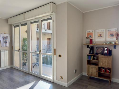 a room with a sliding glass door with a balcony at Vespa Azzurra Apartments Free Parking in Acquaseria