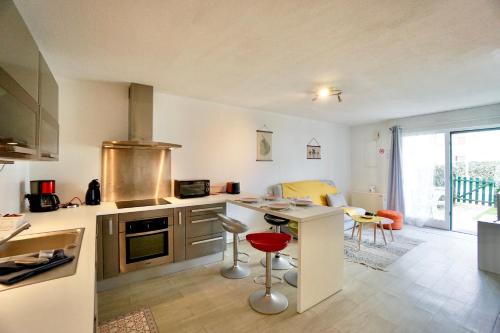 a kitchen with a counter and a stove top oven at Evasion - 100m de la mer - parking in Ploemeur