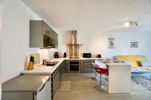 a kitchen with a sink and a counter top at Evasion - 100m de la mer - parking in Ploemeur