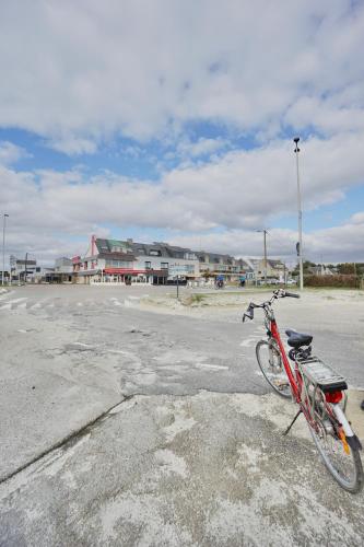 a bike parked on the side of a parking lot at Evasion - 100m de la mer - parking in Ploemeur