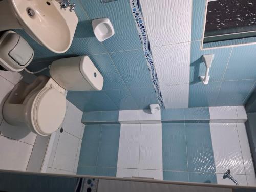 a bathroom with two toilets and a sink at Titicaca Home in Puno