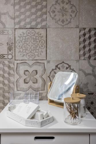 a white counter top with a container and a tile wall at La Grande Bellezza 2 in Lastovo