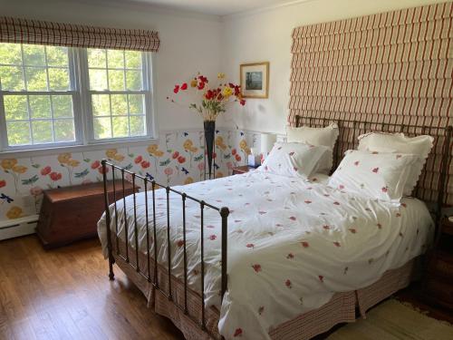 a bedroom with a large bed with flowers on it at Bellport Village Gem in Bellport