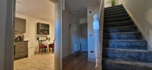 a hallway with a staircase in a home with a kitchen at Refurbed Modern & Stylish 3BD - Garden Pets OK in Dublin