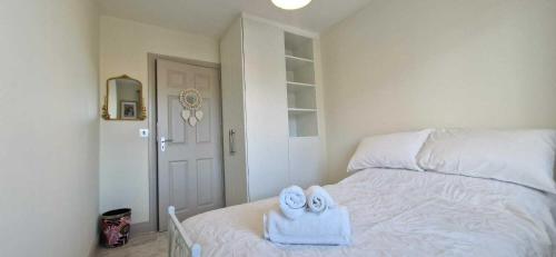 a bedroom with a bed with towels on it at Refurbed Modern & Stylish 3BD - Garden Pets OK in Dublin