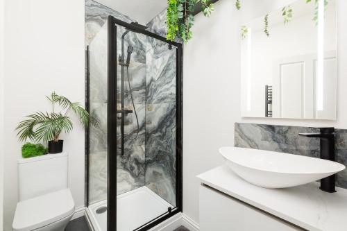 a bathroom with a shower and a sink at Stylish 2-Bedroom Townhouse in Stratford upon Avon in Stratford-upon-Avon