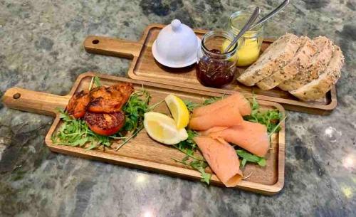 a plate of food with meat and vegetables and bread at The Cowshed Cottage on The Greenway in Dungarvan