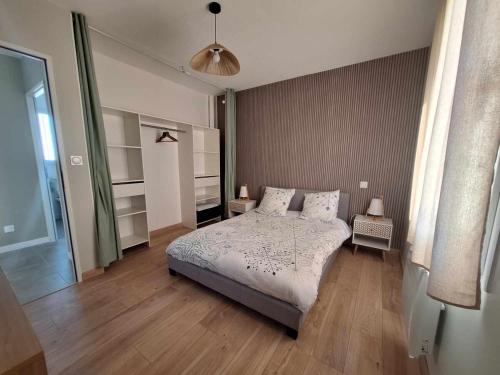 une chambre avec un grand lit dans une pièce dans l'établissement Appartement 5A - Saintes, à Saintes