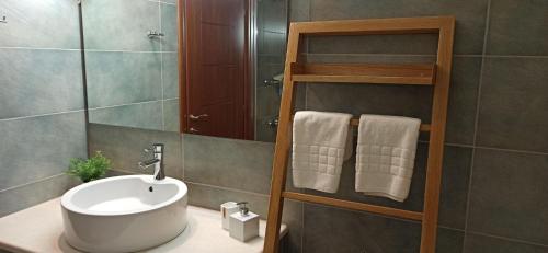 a bathroom with a white sink and a mirror at Luxurious Villa Tholos Crete in Thólos